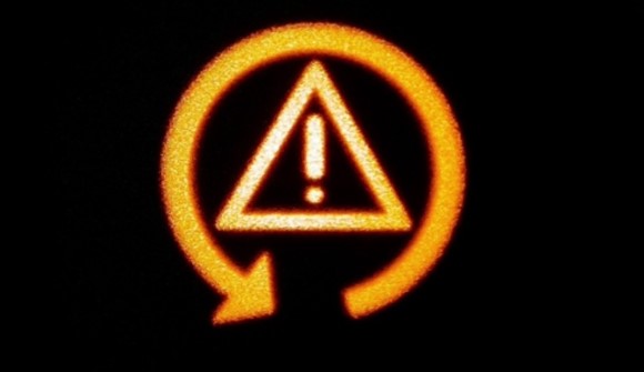 What does a orange triangle light with the exclamation point in a car mean